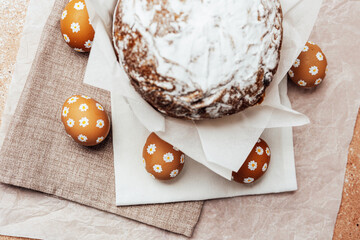 Traditional Easter cake with hand-painted daisy eggs on fabric. Homemade festive baked goods and...