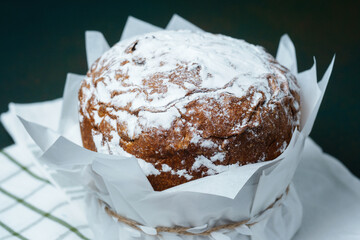 Easter cake with powdered sugar close up on a green background