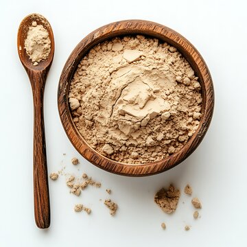 multani mitti powder in a small pile with a spoon beside