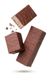 Wafer in chocolate and two halves with crumbs flying on a white background. Isolated