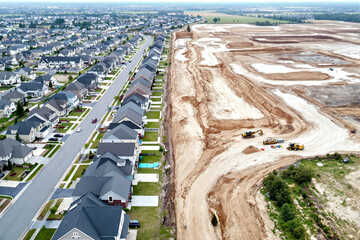 aerial view of residential area adjacent to an active construction site