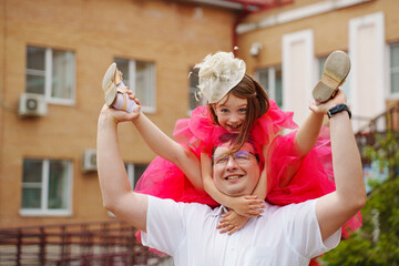 Happy well-dressed family on a walk. Dad and little daughter 