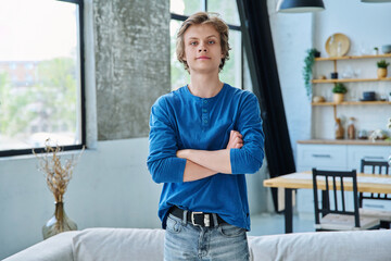 Fototapeta premium Portrait of confident handsome teenage boy with crossed arms