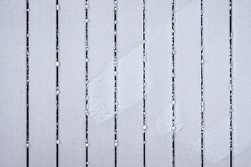 close-up view of a snow-covered surface with vertical lines creating a textured
