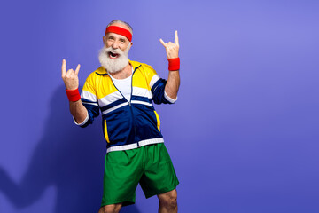 Funny man in retro sporty outfit enthusiastically posing on vibrant background symbolizing youth,...