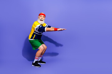Senior male in retro sportswear demonstrating athletic exercise with a vibrant backdrop, expressing healthy and active lifestyle