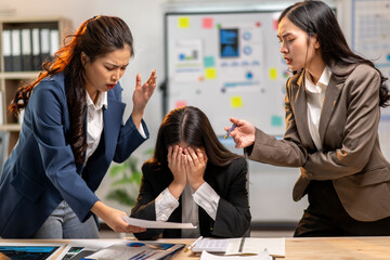 Three women are in a meeting room, one of them is crying