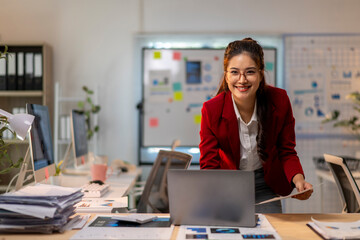 A woman in a red jacket is smiling