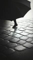 Person with Umbrella on Wet Cobblestones: Moody B&W Scene