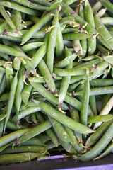 Top view of fresh green peas arranged in basket. A close-up of vegetable in a grocery store. Fresh harvest. Healthy eating vegetable. Organic produce. vegetable market, green peas background,