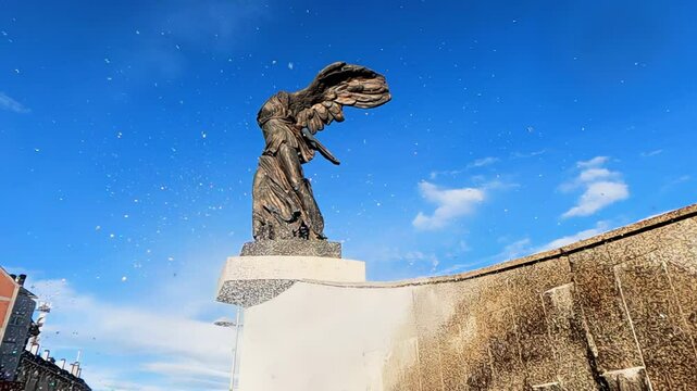 Slow-motion video at the Liberty Monument, small drops of the fountain intermingle with the winged, headless statue replica of the Victory of Samothrace