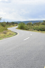 Newly constructed asphalt road with clipping path, asphalt highway road with sky clouds natural landscape, asphalt road passing through agricultural fields under blue sky in Chakwal, Punjab, Pakistan