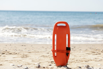 Rescue can on the beach sand, ready for emergencies with tourists on their vacations and enjoying...