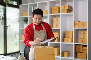 Small business owner managing orders and inventory in office