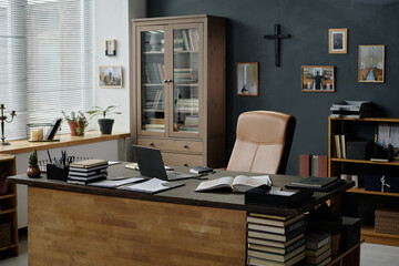 Wide shot of minimalist office of nun fully equipped with modern wooden furniture, bookshelves and bookcases, copy space