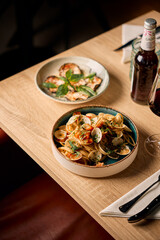 Italian restaurant table set with wine and gourmet pasta