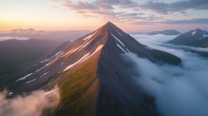 Aerial view of mountain range glowing under the light of the rising sun