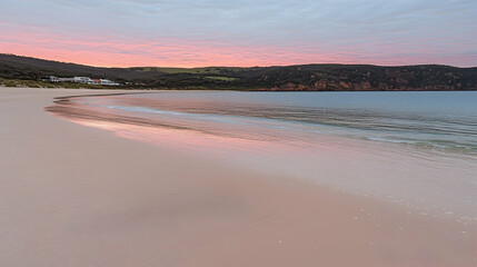 Fototapeta premium Pink sunrise over beach and resort. Beautiful coastal scene. Potential use Travel brochure or postcard