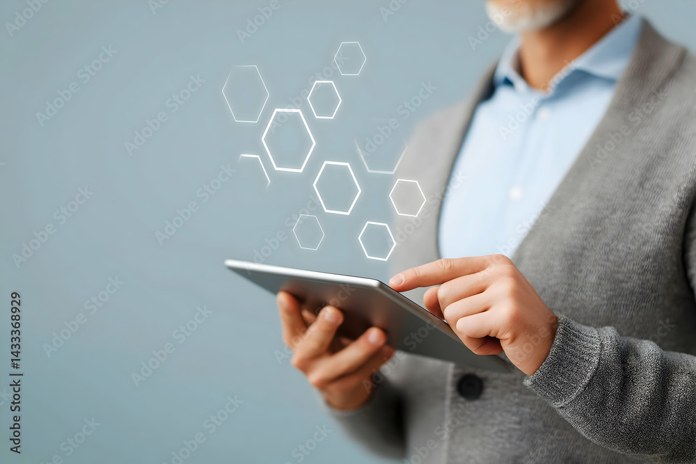 Aufkleber a man using a tablet with digital hexagonal graphics, symbolizing technology and innovation in a mod
