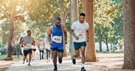 Fototapeta na wymiar Running, competition and race with people in park for charity event, health challenge and fitness. Speed, fundraising marathon and exercise with group of runners in nature for workout and sports