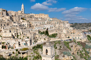Hill and cliffs with buildings and churches on the Gravina di Matera of Matera, Italy, know for the Sassi or Ancient town with its rock-cut urban core and twin cliffside zones, collectively the Sassi