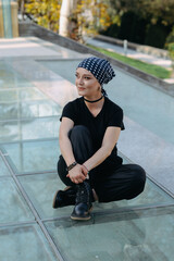 Strong woman wearing mantra scarf in breast cancer awareness, looking with hope