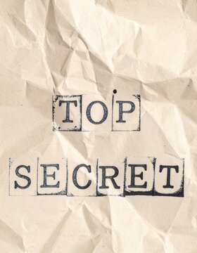 Crumpled paper with top secret stamped in black ink
