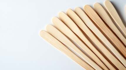 Wooden sticks present smooth, simple pattern against white backdrop, suggesting clean, minimalist style.