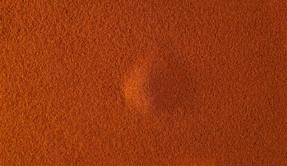 Spicy chili red pepper ground, milled dry paprika background and texture, top view