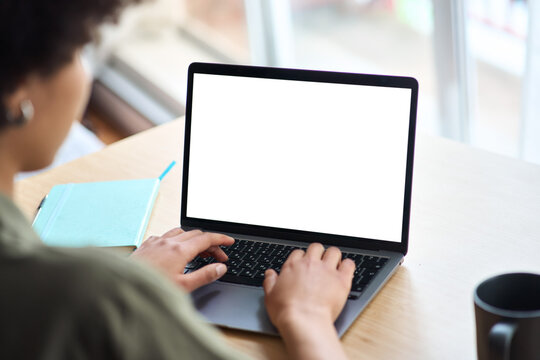 Over shoulder view of African American woman student elearning looking at white mock up blank screen using laptop computer learning online, hybrid working. Website mockup display template for ads.