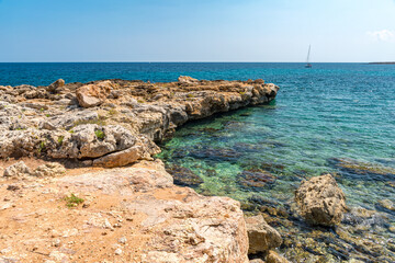 Rocky coastline at Punta Asparano, a promontory near Siracusa, during the summer;  Sicily, Italy