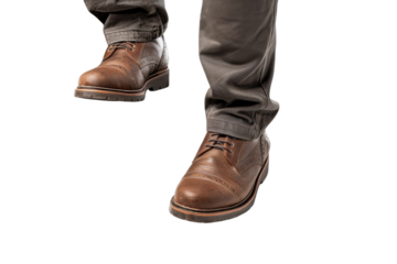 Stylish brown leather shoes worn with gray pants during a casual outing