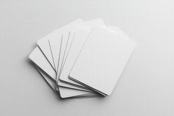 A stack of blank white cards on a white surface