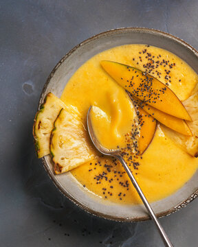 Tropical mango pineapple smoothie bowl with chia seeds