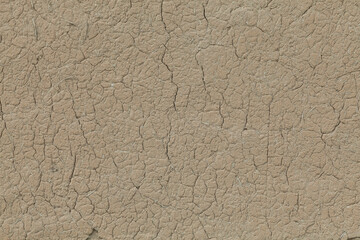 cracked clay wall with adobe straw as background