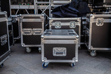 Cases for the transportation of concert equipment. Black cases on wheels. Transportation and storage of musical equipment. Protective boxes for transporting musical equipment.