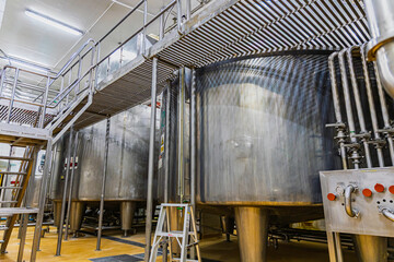 Stainless vertical steel tanks and pipes with pressure meter in equipment tank chemical cellar at the with stainless