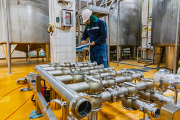 Male work inspection process stainless steel pipe stainless with pressure meter in equipment tank...