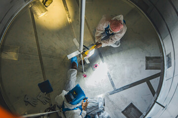 Top view male climb up the stairs into the tank stainless chemical area confined space save lives with rescue