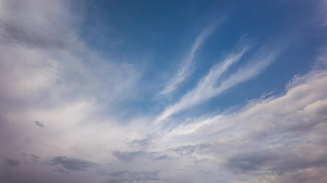 Ethereal Cirrus Clouds Moving Across Blue Sky