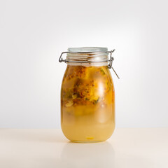  Tepache, fermented mexican pineapple beverage, in a glass jar, selective focus