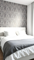 Obraz premium Comfortable bed with pillows and sheet in white modern bedroom with stylish wallpaper on the wall. Cozy interior of room in hotel to sleep. Relax and minimal style, vector style. White tone