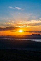 Naklejka premium araffes flying a kite at sunset over a lake