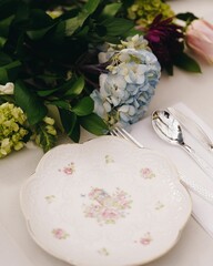 Elegant table setting with floral elements.
