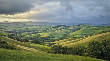 Fototapeta premium Vibrant Rainbow Arching Over Rolling Hills