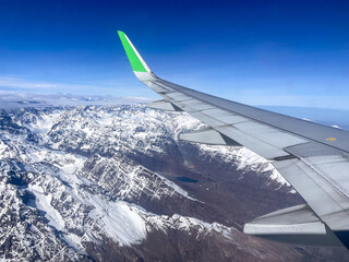View from outside the airplane window of the ice mountains of the Andes, Patagonia, Argentina..
