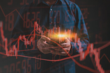 Financial and Investment Stock Market Recession and Losses ,Businessman using mobile or smartphone analysing trading downtrend line graph in bear market
