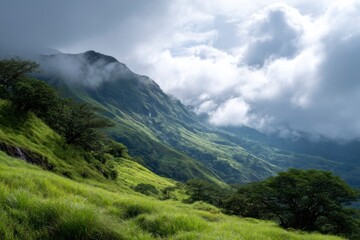 Obraz premium Green Mountain Landscape with Cloudscape and Waterfall in the Distance