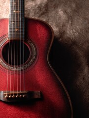 Close-up of a Red Acoustic Guitar Body with Texture Backdrop