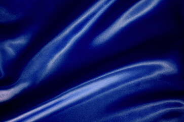 Top view of dark blue silk cloth with silky sheen suitable for design and wallpaper background